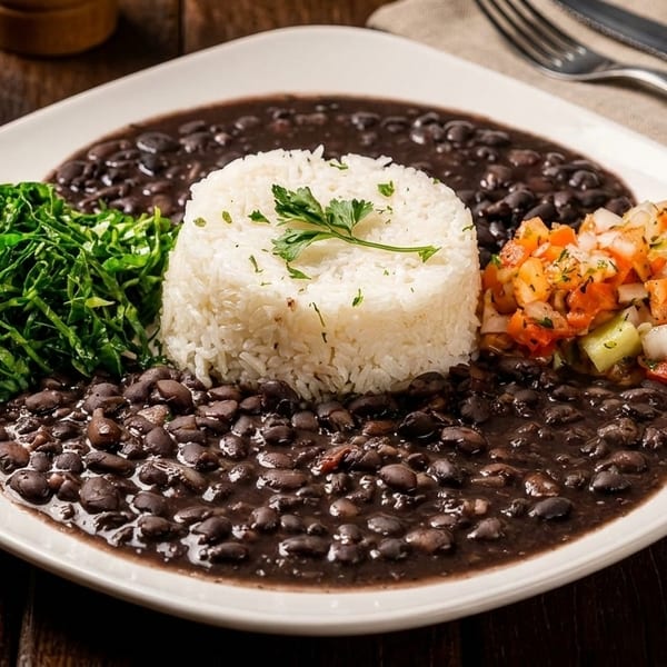 A white plate with black beans, white rice, collard greens, and pico de gallo.